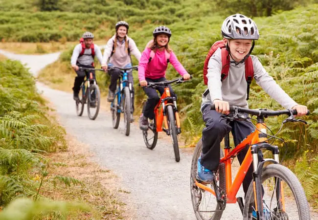 Family on a bike ride enjoying the outdoors while on vacation.