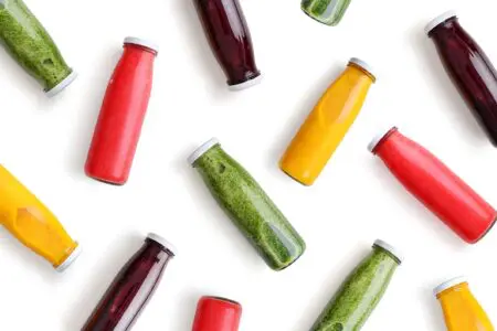 Colorful smoothies in glass bottles.
