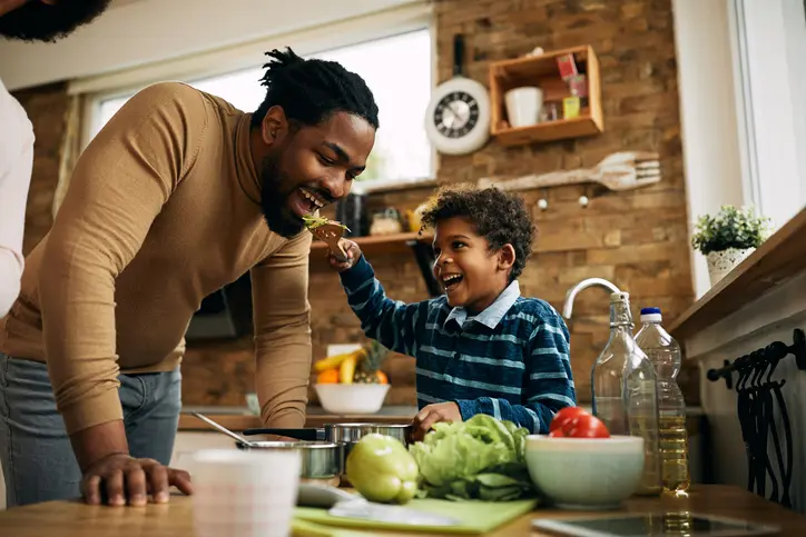 A father and son enjoy preparing healthy food