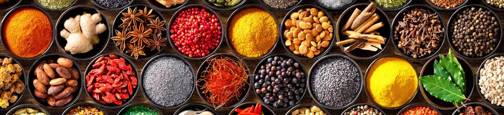 Colourful background from various herbs and spices for cooking in bowls