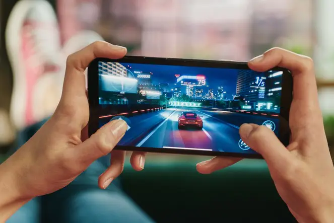 Woman gaming on mobile device