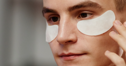 Male consumer engaging with skincare products.