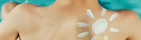 Sunscreen rubbed in on a person's back.