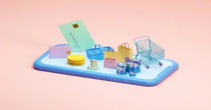 Smartphone lying flat with shopping bags, cart, basket, and modes of payment on top of it.
