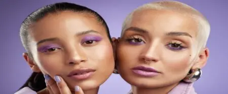 Two women with a noticeable polished make up look.