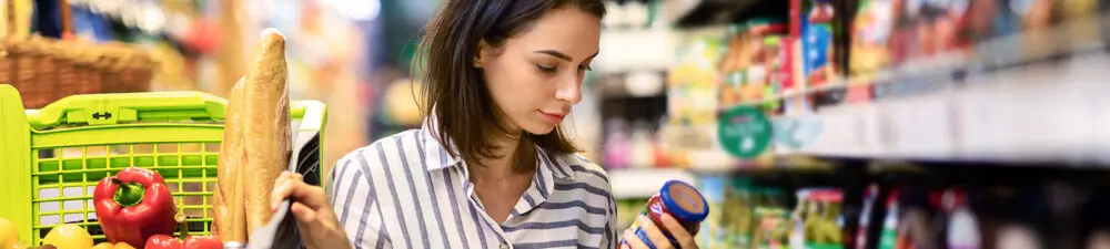 Lady looking at a product in a grocery store