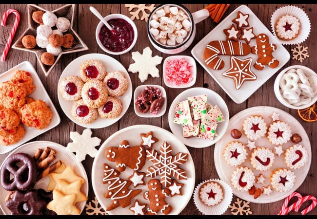 Table full of Christmas food including mince pies and gingerbread men