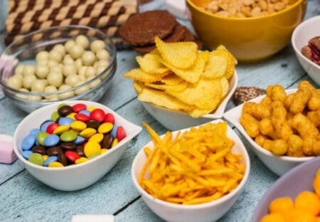 Salty snacks displayed in bowls on a table.