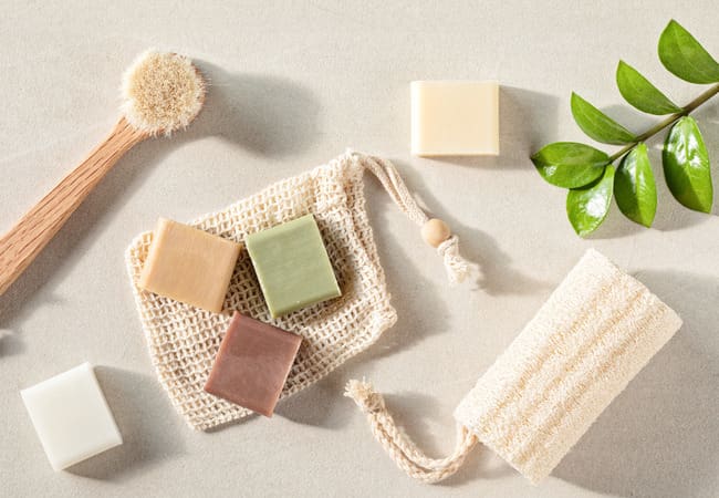 Eco-friendly beauty products including soap bars and a loafer