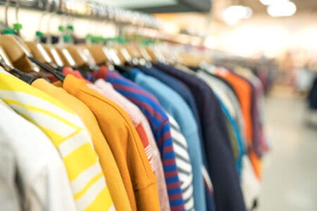 Colourful clothes on a shop rack