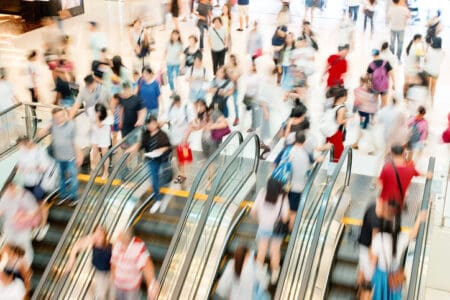 lots of people joining escalators in a shopping mall