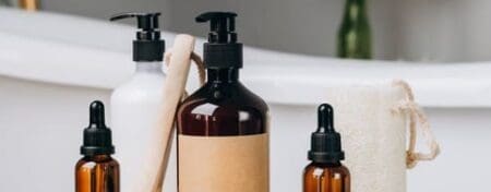Assortment of bottles containing personal care products.