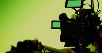 Green background with a high-tech canera shooting for a film