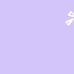 A hand holds a lit, yellow lightbulb against a purple background to signify innovation.